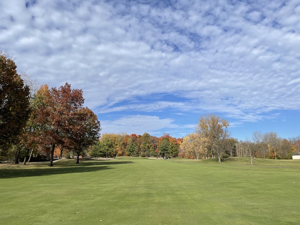 Panoramic view of a lush green golf course at Fox Creek Golf Course. Smooth