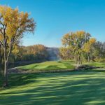 Panoramic view of a lush green golf course at Fox Hollow Golf Club. Smooth