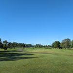 Panoramic view of a lush green golf course at Fox Run Golf Links. Smooth