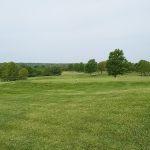 Panoramic view of a lush green golf course at Fred Arbanas Golf Course. Smooth