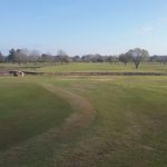 Panoramic view of a lush green golf course at Frenchman's Bend. Smooth