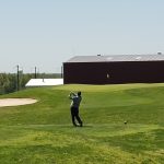 green grass with the flag in the hole.