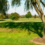 Panoramic view of a lush green golf course at Gambler Ridge Golf Course. Smooth