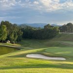 Panoramic view of a lush green golf course at Gatlinburg Golf Course. Smooth