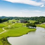 Panoramic view of a lush green golf course at Gaylord Springs Golf Links. Smooth