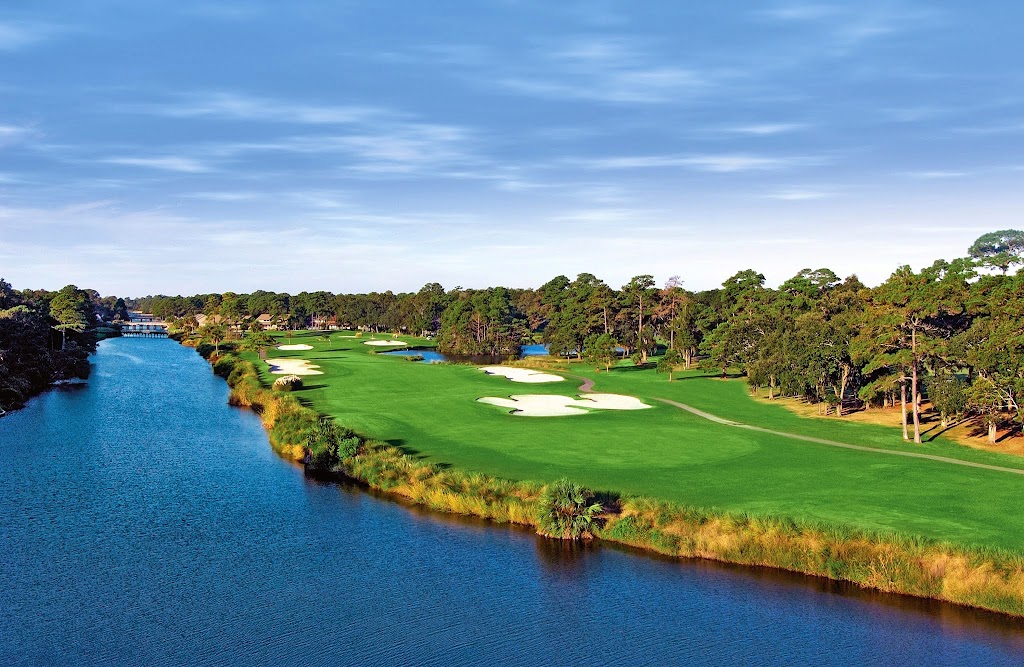 Panoramic view of a lush green golf course at George Fazio Golf Course. Smooth