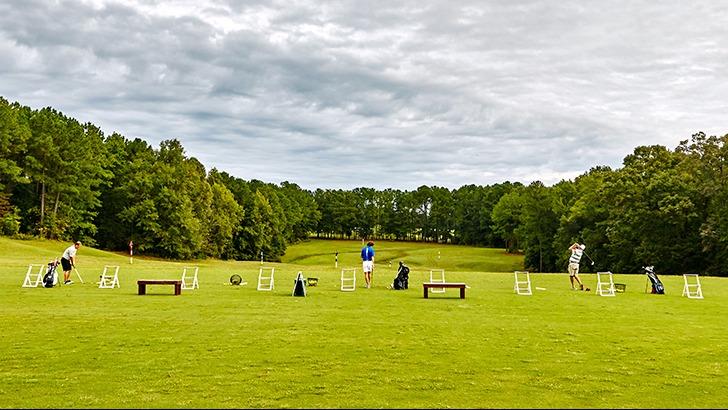 Panoramic view of a lush green golf course at Georgia National Golf Club. Smooth