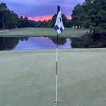green grass with the flag in the hole.