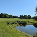 Panoramic view of a lush green golf course at Glade Valley Golf Club. Smooth