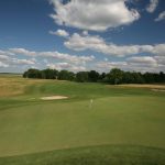 green grass with the flag in the hole.