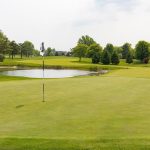 green grass with the flag in the hole.