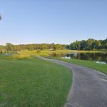 Panoramic view of a lush green golf course at Glenwood Country Club. Smooth