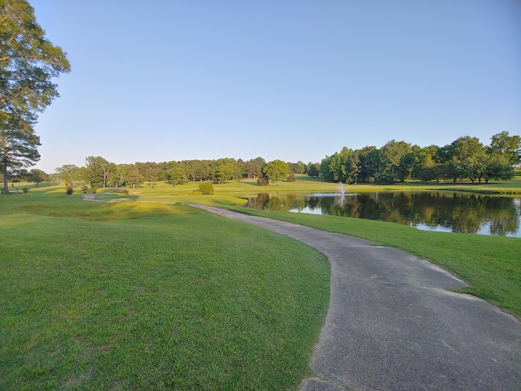 Panoramic view of a lush green golf course at Glenwood Country Club. Smooth