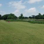 Panoramic view of a lush green golf course at Golf Club At Cimarron Trails. Smooth