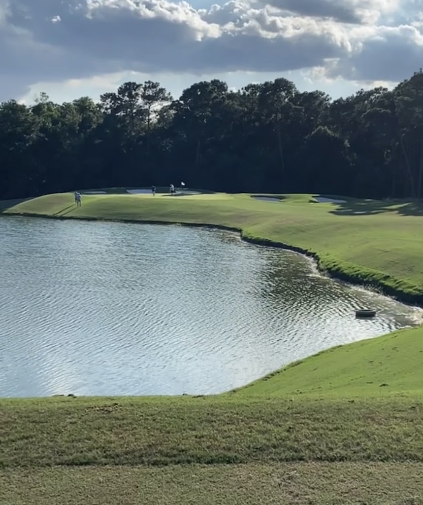 Panoramic view of a lush green golf course at Golf Club of Houston. Smooth