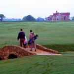 Panoramic view of a lush green golf course at Golf Clubs at The Tribute. Smooth
