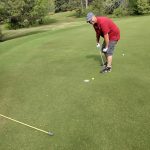 green grass with the flag in the hole.