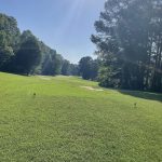 Panoramic view of a lush green golf course at Golf North Hills. Smooth