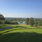Panoramic view of a lush green golf course at Golf on Turkey Mountain. Smooth