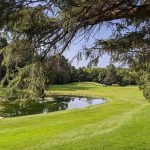 Panoramic view of a lush green golf course at Goodrich Golf Course. Smooth