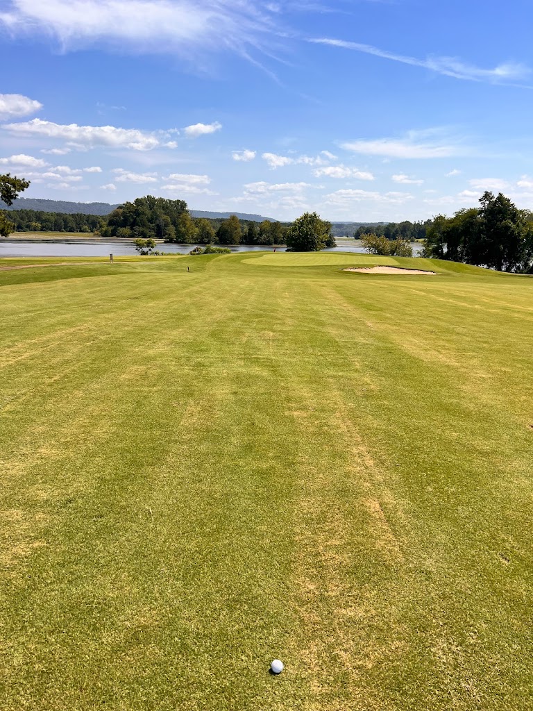 Panoramic view of a lush green golf course at Goose Pond Colony Lake Course. Smooth