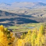 Panoramic view of a lush green golf course at Granby Ranch Golf Course. Smooth