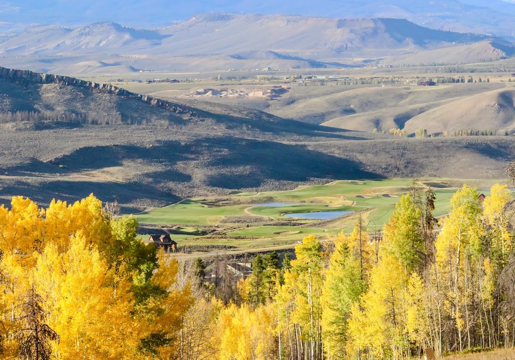 Panoramic view of a lush green golf course at Granby Ranch Golf Course. Smooth