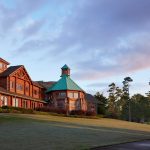 Panoramic view of a lush green golf course at Grand Bear Golf Club. Smooth