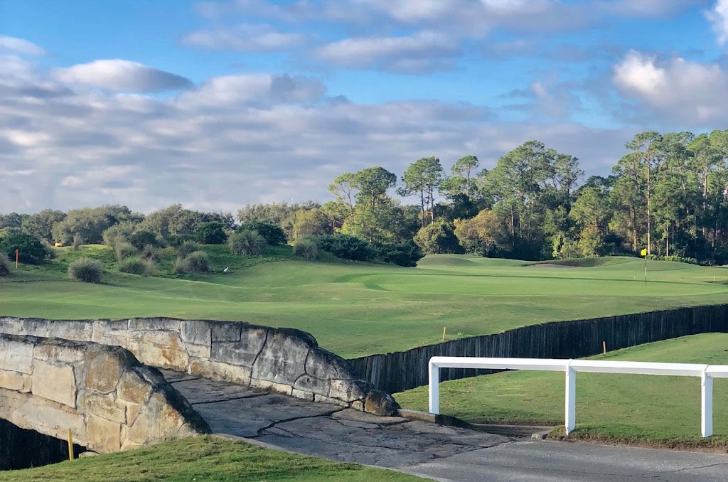 Panoramic view of a lush green golf course at Grand Cypress Golf. Smooth