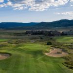 Panoramic view of a lush green golf course at Grand Elk Golf Club. Smooth