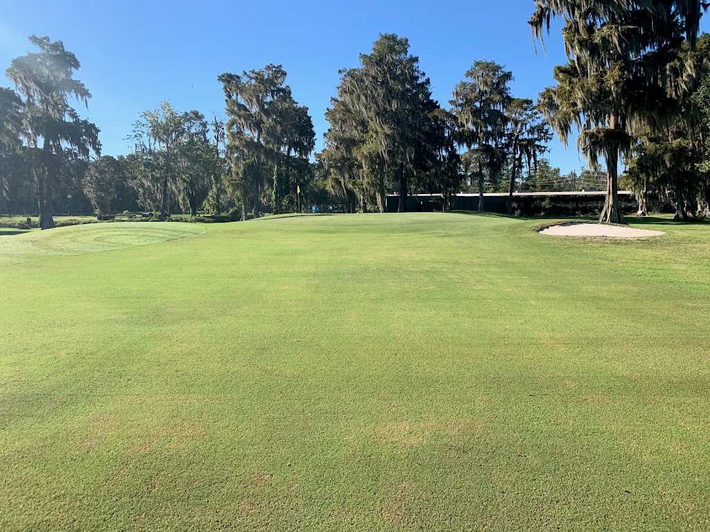 Panoramic view of a lush green golf course at Grand Ridge Golf Club. Smooth