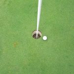 green grass with the flag in the hole.