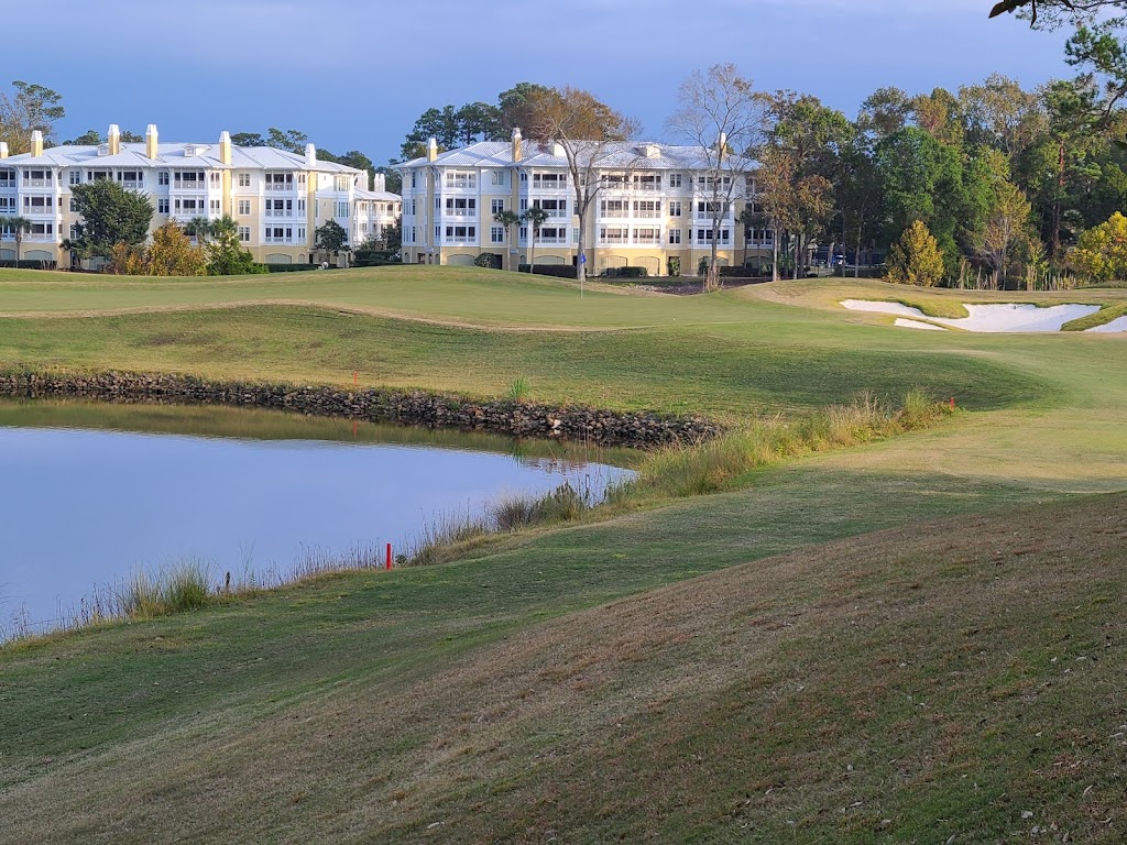 Panoramic view of a lush green golf course at Grande Dunes Resort Club. Smooth
