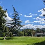 Panoramic view of a lush green golf course at Grants Pass Golf Club. Smooth