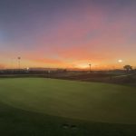 green grass with the flag in the hole.