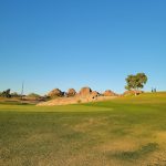 Panoramic view of a lush green golf course at Grass Clippings Rolling Hills. Smooth