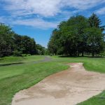 Panoramic view of a lush green golf course at Grassmere Country Club. Smooth