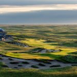 Panoramic view of a lush green golf course at GrayBull Club. Smooth