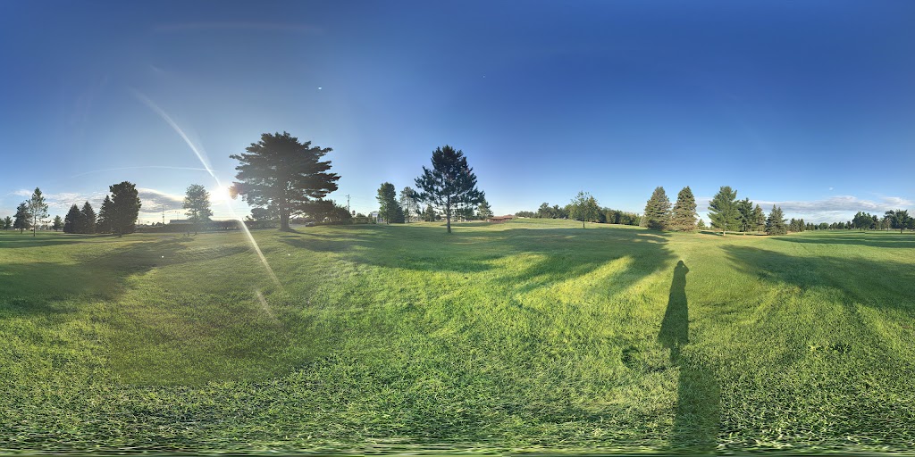Panoramic view of a lush green golf course at Grayling Country Club. Smooth
