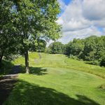 Panoramic view of a lush green golf course at Great Bear Golf Club. Smooth