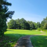 Panoramic view of a lush green golf course at Green Briar Golf. Smooth