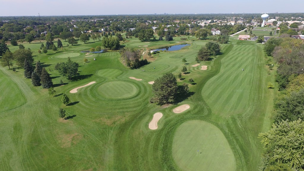 Panoramic view of a lush green golf course at Green Meadows. Smooth