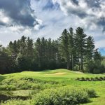 Panoramic view of a lush green golf course at Green Mountain National Golf Course. Smooth