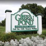 Panoramic view of a lush green golf course at Green Pond Country Club. Smooth
