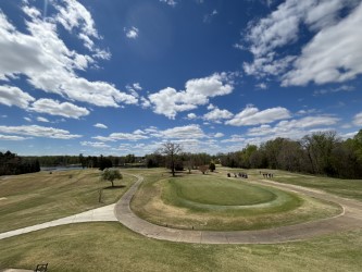 Panoramic view of a lush green golf course at Greensboro National Golf Club. Smooth