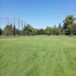 Panoramic view of a lush green golf course at Gresham Golf Course. Smooth