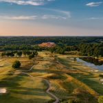 Panoramic view of a lush green golf course at GreyStone Golf Club. Smooth