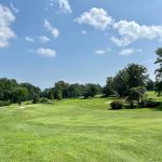Panoramic view of a lush green golf course at Griffith E Harris Golf Course. Smooth