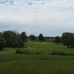 Panoramic view of a lush green golf course at Griswold Golf Club. Smooth