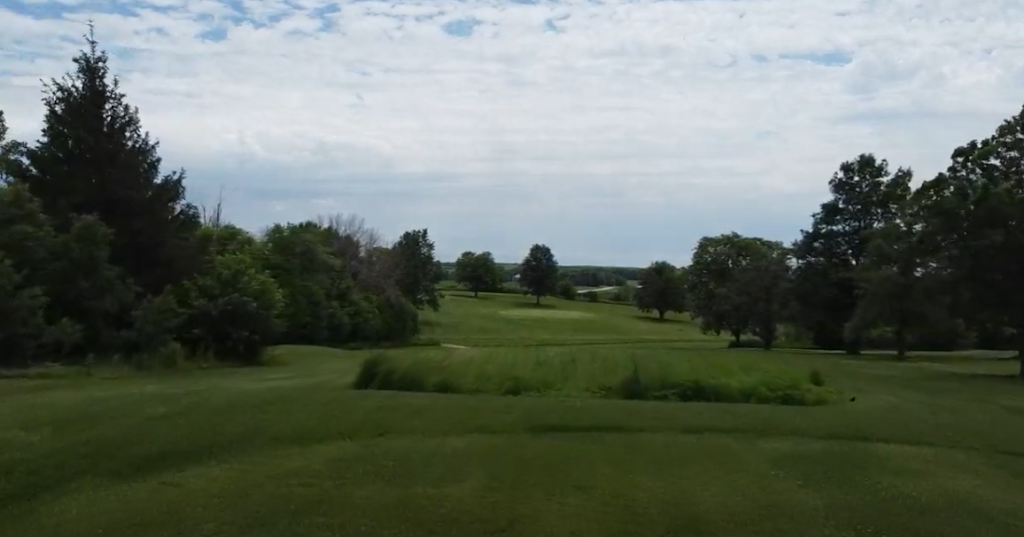 Panoramic view of a lush green golf course at Griswold Golf Club. Smooth